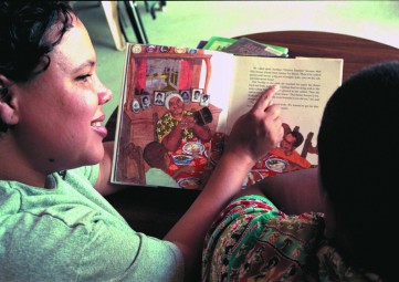 Washington Reading Corps member reads to a child (photo by Jennifer Loomis)