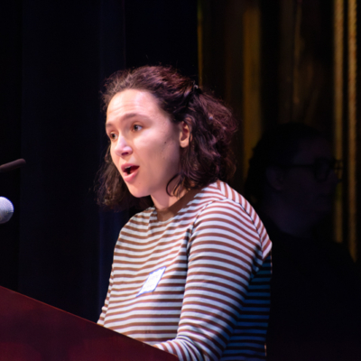 Closeup of a woman speaking at a lectern.