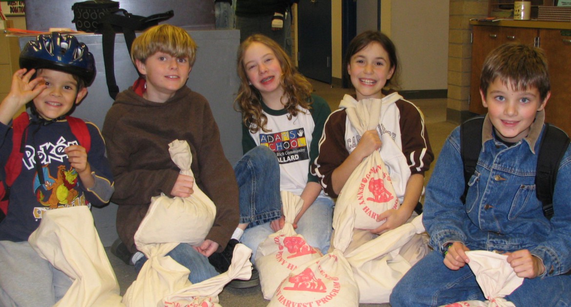 Students at a Penny Harvest school show off their coins