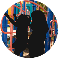 Silhouette of a mother and daughter at a jungle gym