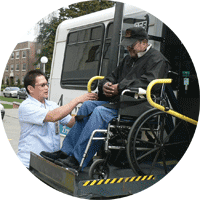 SPT driver Roland Remolana raises a passenger, Mr. Moore, and his wheelchair onto a Metro ACCESS van.