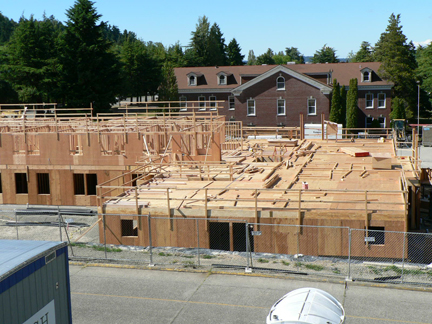 Building 5 takes shape south of the long barracks building on Sand Point Way.