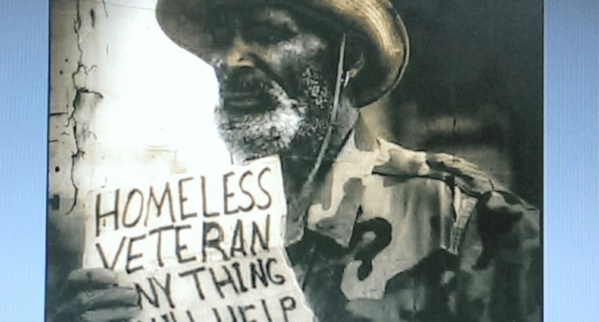 Homeless vet holding sign asking for help