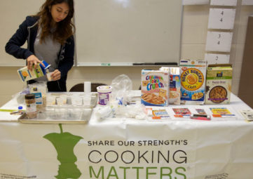AmeriCorps member Michelle Huete prepares for a pop-up Cooking Matters at the Store tour.
