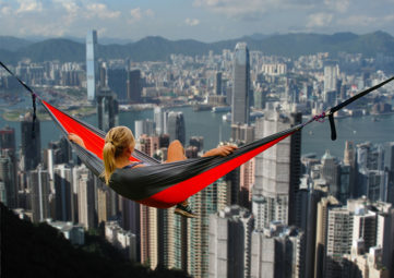 Woman in hammock over Hong Kong