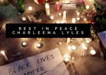 Flowers and candles creating a shrine to Charleena Lyles