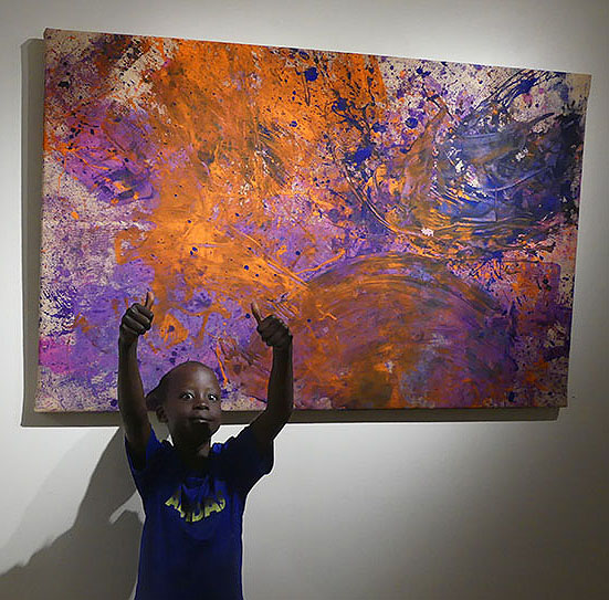 Young artist, Dang, gives two thumbs up to a gorgeous piece the group created together