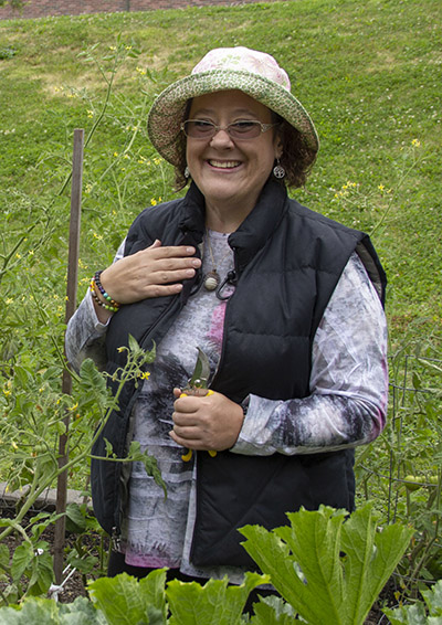 Adrienne Karls tends to the tomato plants.