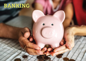 Banking: Hands of multiple generations hold a piggy bank