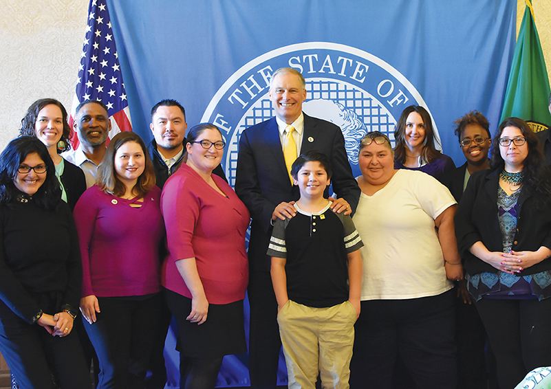 Members of the Poverty Reduction Work Group (PRWG) pose with Governor Jay Inslee, including Solid Ground Advocacy Director Marcy Bowers (2nd from left) & Statewide Poverty Action Network Board Chair Juanita Maestas with her grandson Anthony (4th & 5th from right).
