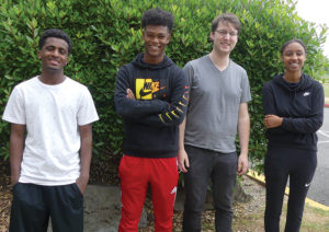 Three college-bound graduates laugh with their tutoring program lead, Sand Point Housing Children’s Advocate Oliver Alexander-Adams. (L to r): Semere, Bereket, Oliver, and Mekedes