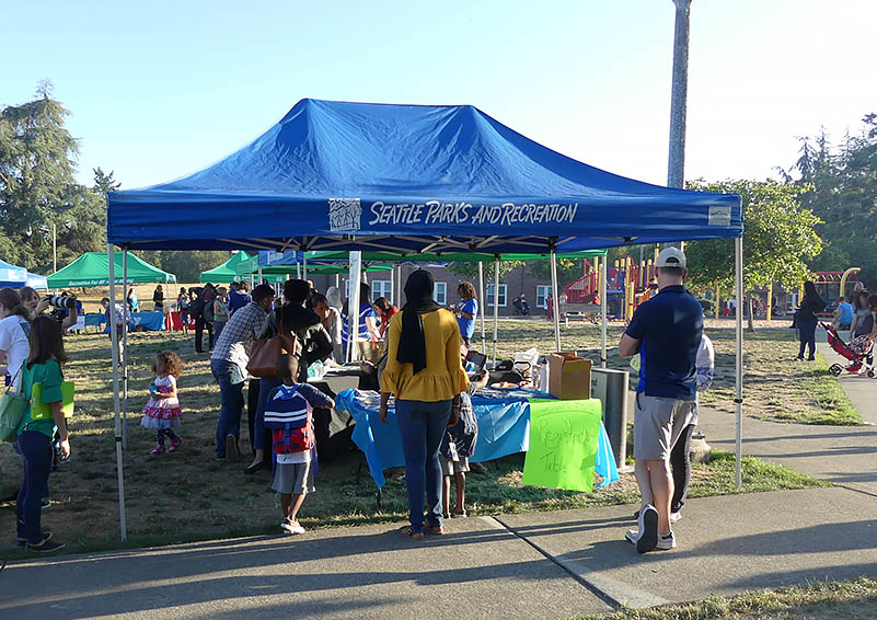 Families stand at the entrance to the back-to-school tabling area.