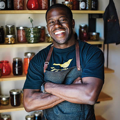 Chef Edouardo Jordan in his pickle pantry (photo by Shannon Renfroe)