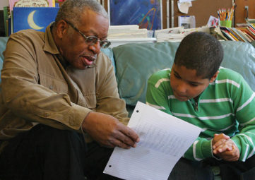 Older man tutors young boy