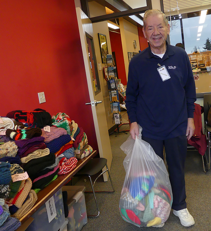 Man with a bag of warm knitted items for donation, Nov. 2012