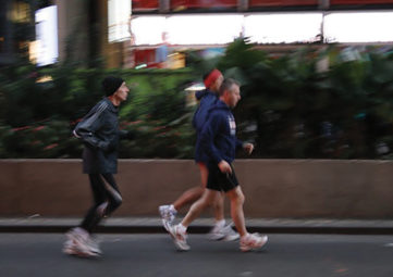 Stock image of three men jogging together