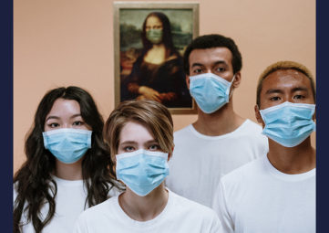 Four young adults, one Asian, one white, two black, wearing white T-shirts & blue face masks, with a picture of the Mona Lisa wearing a face mask behind them