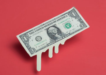 Melting, dripping dollar bill on a red background.