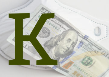 A large green letter K in front of a marked-up $100 bill over a white face mask