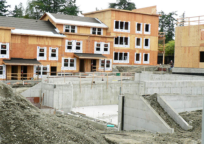 Large apartment complex under construction with unfinished exterior