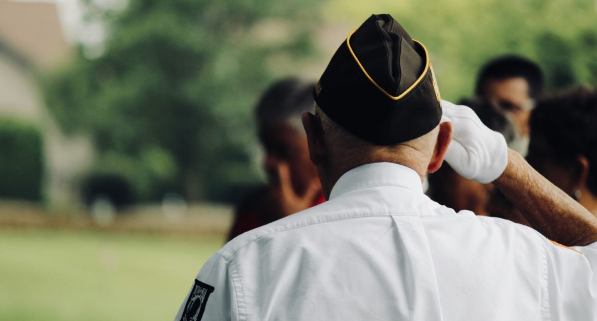 A military veteran saluting.
