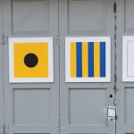 A series of painting mimicking aviation flags.