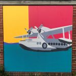 A mural of a twin-propeller airplain