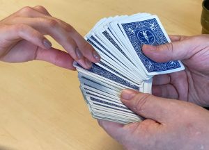 Someone selects a card from a fanned-out deck of cards