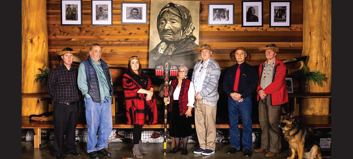 A group of Duwamish tribal elders gathered under a portrait of Chief Seattle's daughter, Kikisoblu.