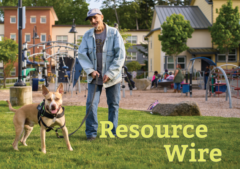 A man in a jean jacket with his dog on a leash on the grass in front of a playground, with the words "Resource Wire" embossed over the grass.
