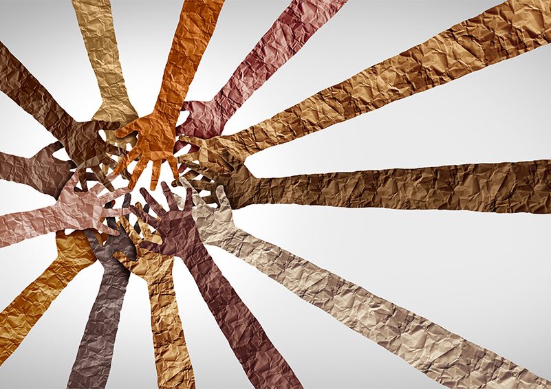 A sunburst of arms made out of crinkled paper in multi-shades of brown.