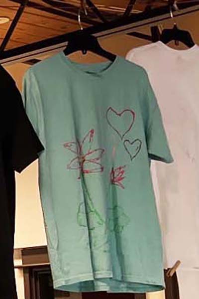 Aqua T-shirt with hearts and flowers drawn on it