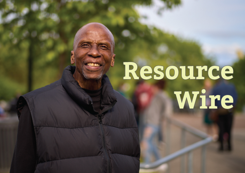 A smiling man wearing a black puffy vest over a black long-sleeve shirt. The words "Resource Wire" appear on the image.