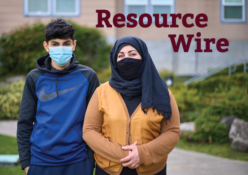 A young man man with dark hair wearing a blue hoodie stands beside his mother, who is wearing a mustard-yellow jacket and a headscarf over her hair. The words "Resource Wire" appear on the image.