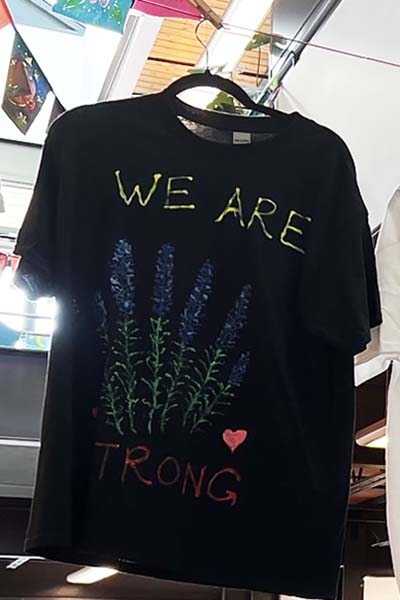 Black T-shirt with the text WE ARE STRONG
