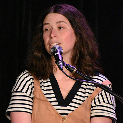 A woman speaking into a microphone.
