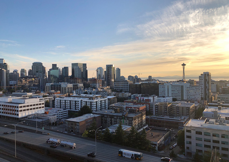 A view of the downtown Seattle Skyline with I-5 in the foreground and the Space Needle in the distance.