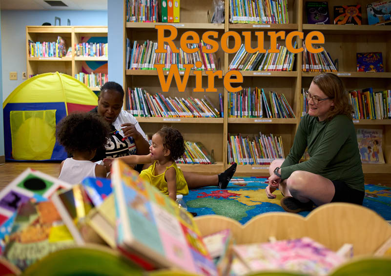 A mother and her daughter play on the floor with a librarian in front of a bookcase filled with colorful books. The words "resource wire" appear above them.