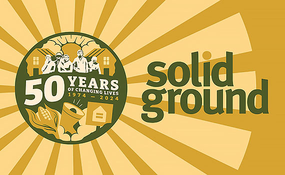 Solid Ground commemorative logo on a golden sunburst background with a circular dark green, peach and ivory graphic. It has silhouettes of several people in front of a pair of houses. The sun is shining from between two clouds. Text reads 