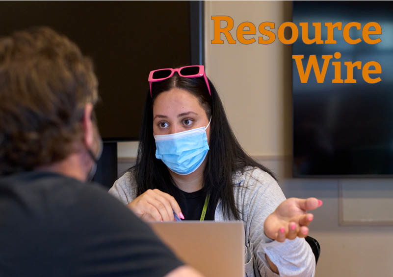 A woman wearing a mask over her mouth and sunglasses resting on her head gestures as she talks to a man whose back is turned to us. The words "Resource Wire" appear above them.