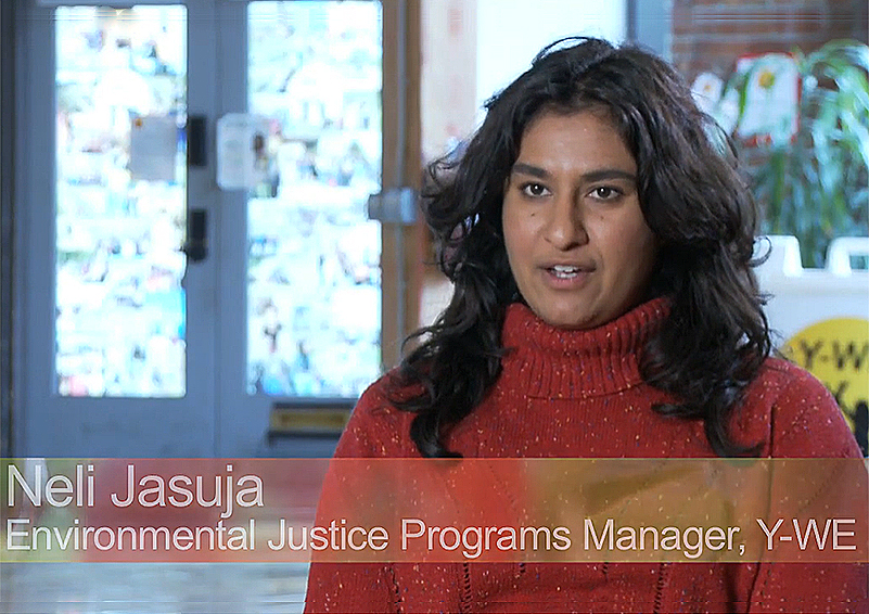 A screenshot of a woman with long dark hair and a red sweater giving an interview. A banner at the bottom of the image reads: "Neli Jasuja, Environmental Justice Programs Manager, Y-WE"