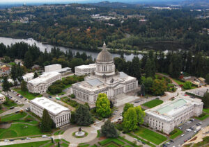 An aerial view of the Washington state capitol and surrounding buildings, with Capitol Lake in the background.