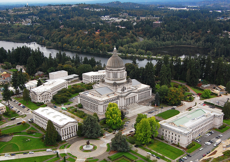 An aerial view of the Washington state capitol and surrounding buildings, with Capitol Lake in the background.