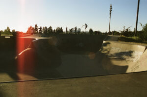 Photo of youth at a skate park in golden afternoon light.