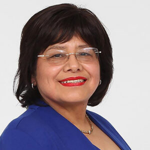 Headshot of a smiling woman with short black hair wearing glasses and a bright blue blazer.
