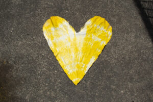 A yellow tie-dyed cloth heart