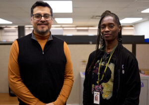 Portrait of a man with dark hair and glasses and a woman with long dark braids.