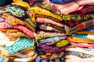 Stacks of colorful knitted items