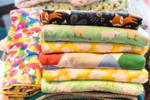 Stacks of colorful flannel and knitted items