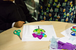 A color crepe-paper leaf on a table.